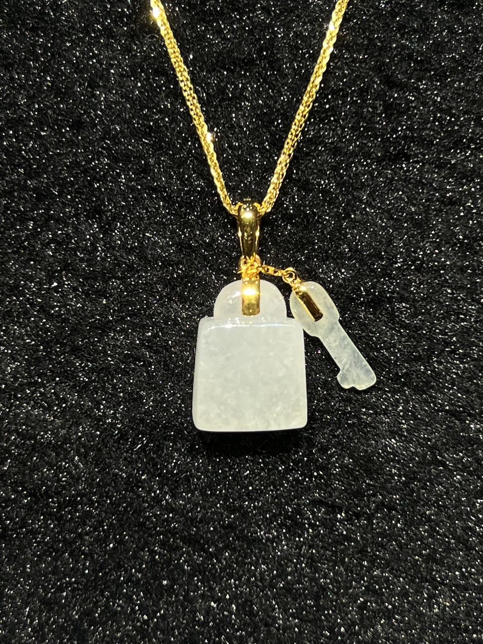 Icy translucent key and lock jadeite pendant
