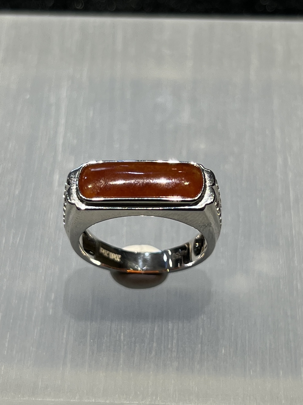 Icy translucent reddish saddle jadeite ring