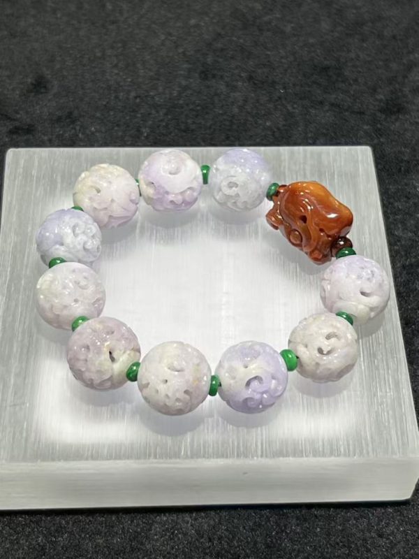 Translucent lavender jadeite carved beads bracelet with reddish dragon head centerpiece from Nanyang Jade Singapore.