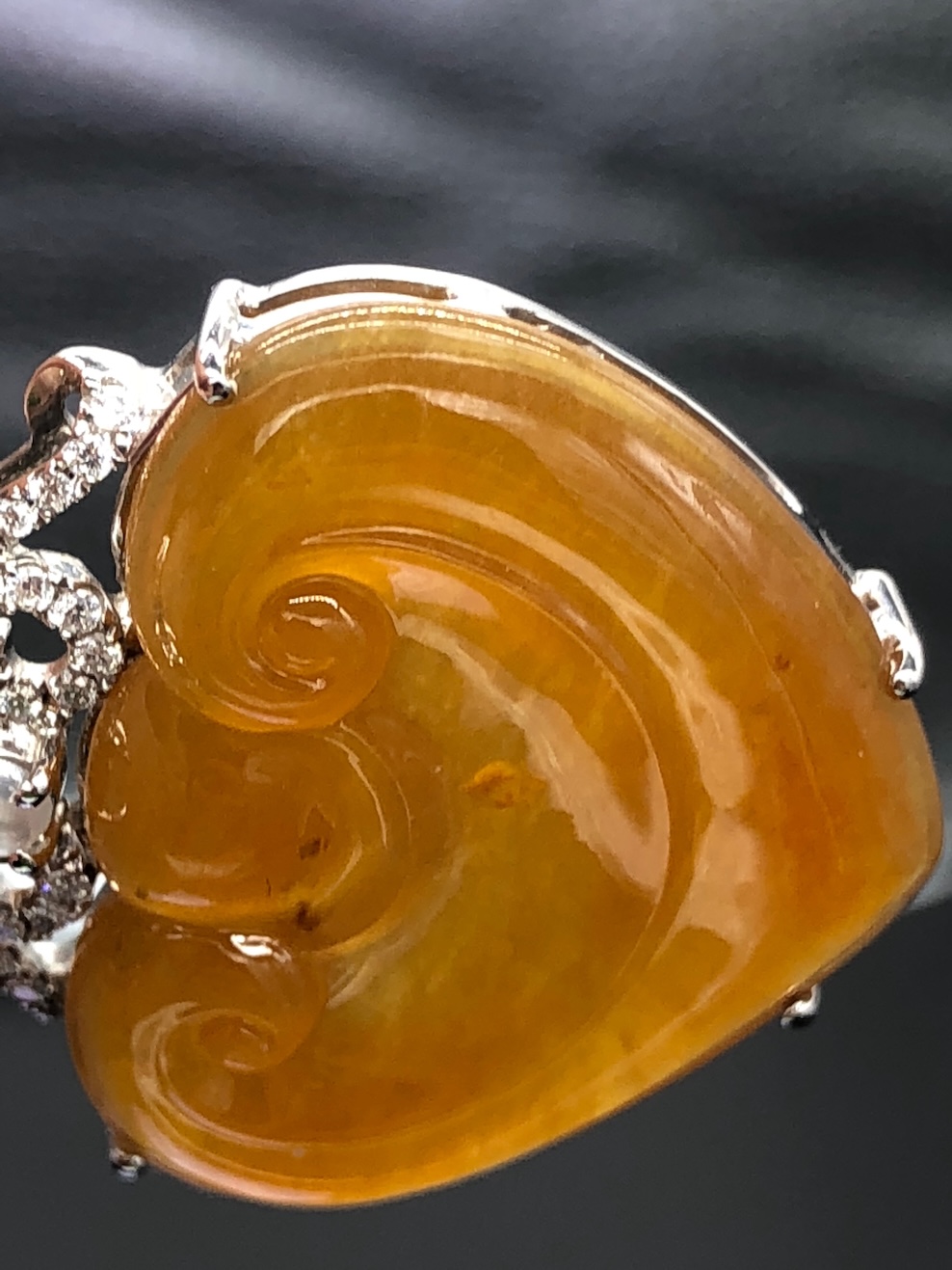 Translucent honey orange jadeite heart pendant with Ruyi carving, white gold setting and diamonds