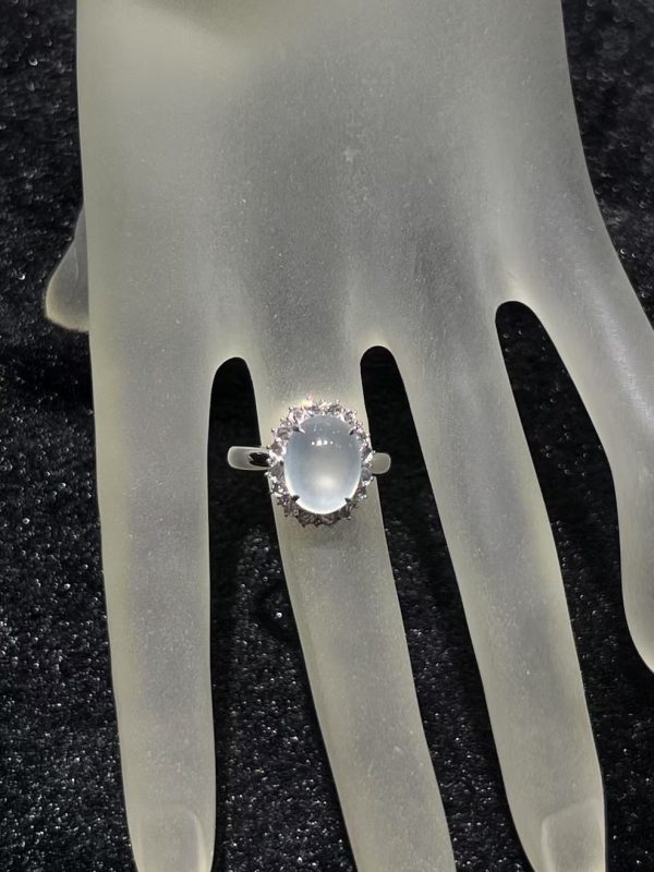 Highly translucent icy jadeite cabochon ring with diamond halo in 18K white gold