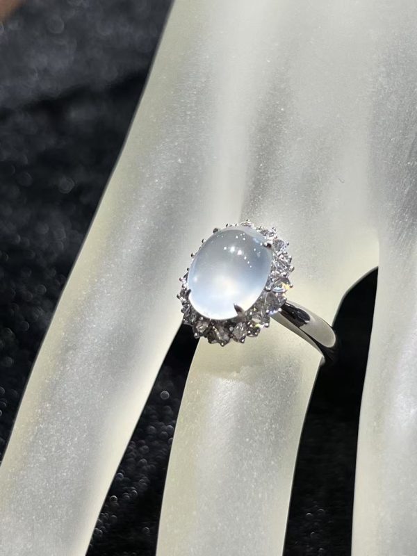 Highly translucent icy jadeite cabochon ring with diamond halo in 18K white gold