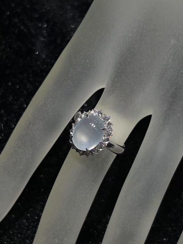 Highly translucent icy jadeite cabochon ring with diamond halo in 18K white gold