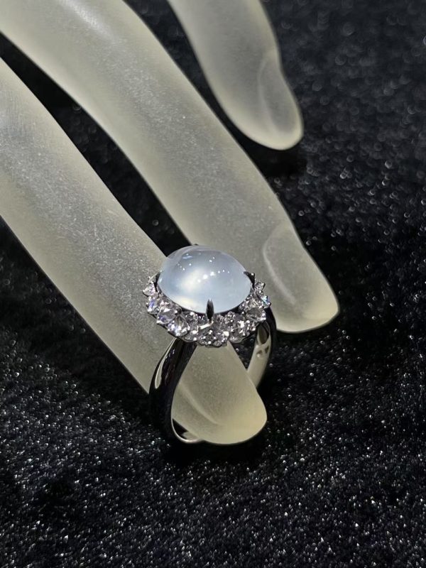 Highly translucent icy jadeite cabochon ring with diamond halo in 18K white gold