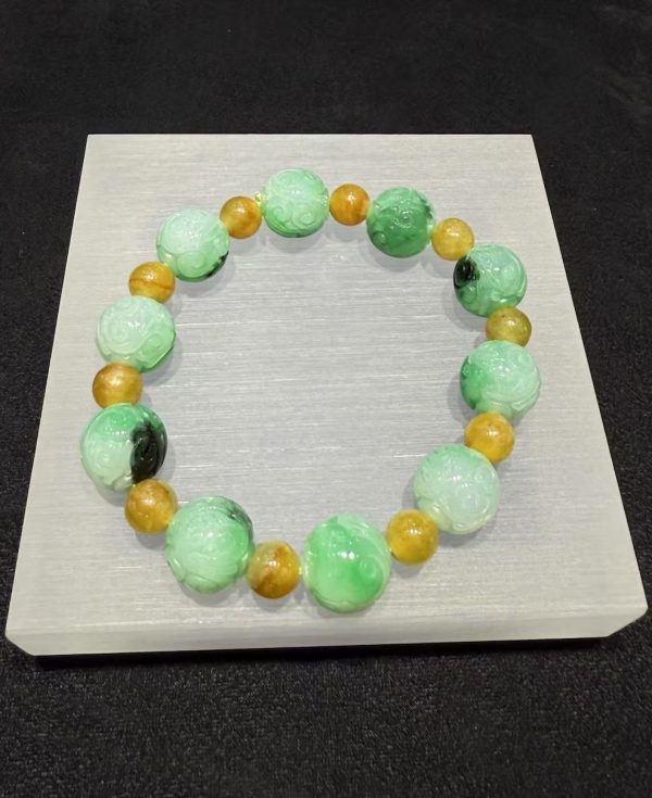 Translucent whitish green jade bracelet with Ruyi cloud carving and golden accent beads