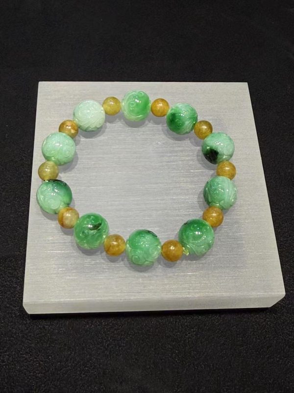 Translucent whitish green jade bracelet with Ruyi cloud carving and golden accent beads