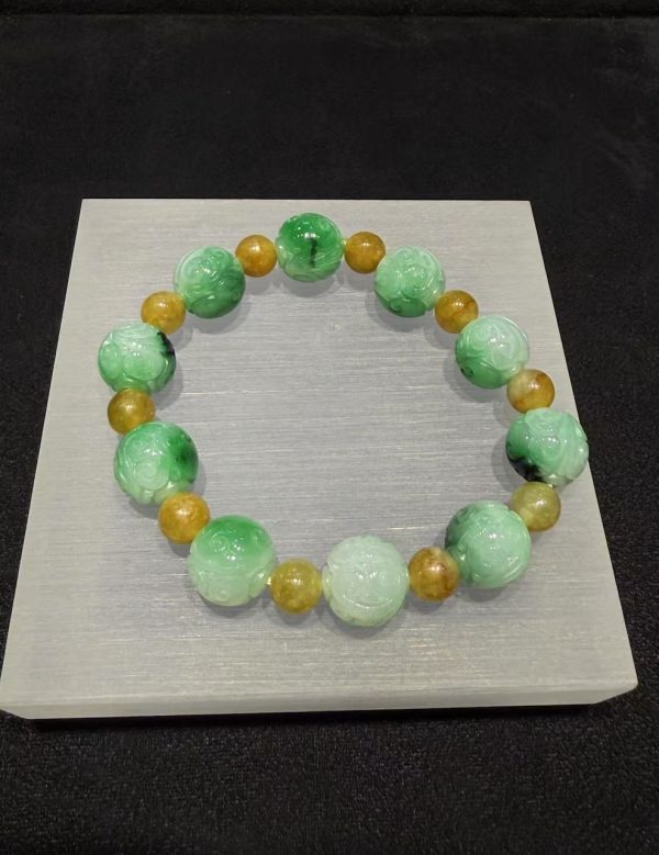 Translucent whitish green jade bracelet with Ruyi cloud carving and golden accent beads