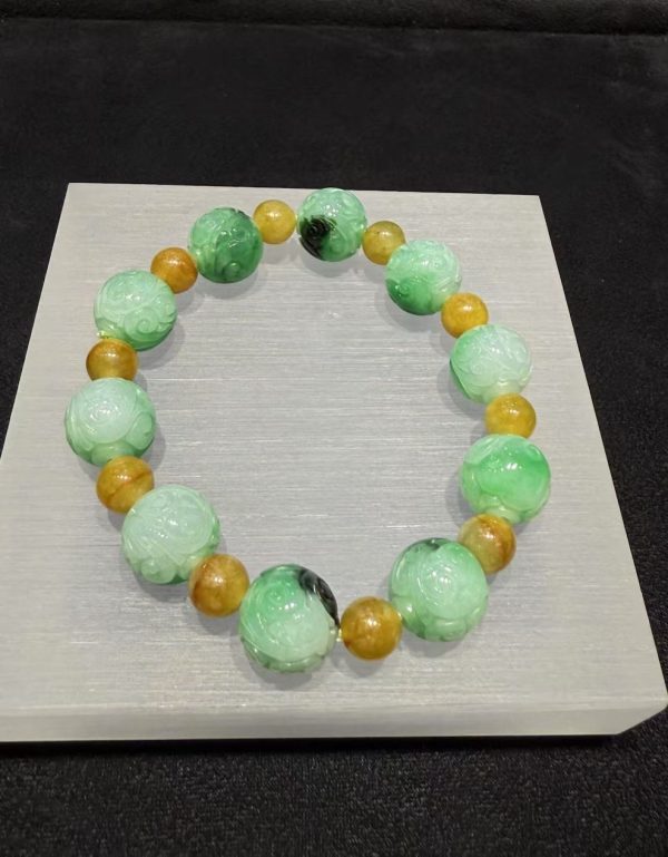 Translucent whitish green jade bracelet with Ruyi cloud carving and golden accent beads