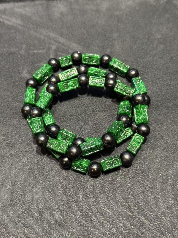Vibrant dark green Ruyi cloud carving jade necklace with black beads