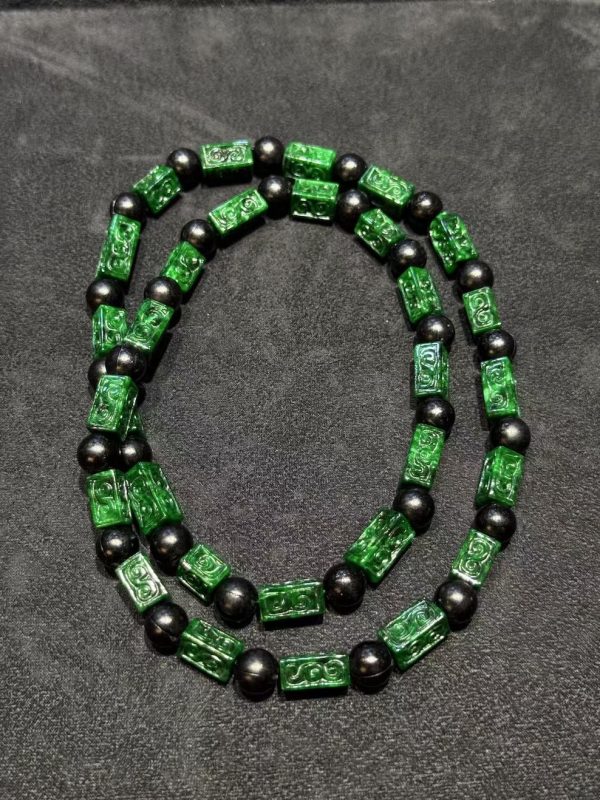 Vibrant dark green Ruyi cloud carving jade necklace with black beads