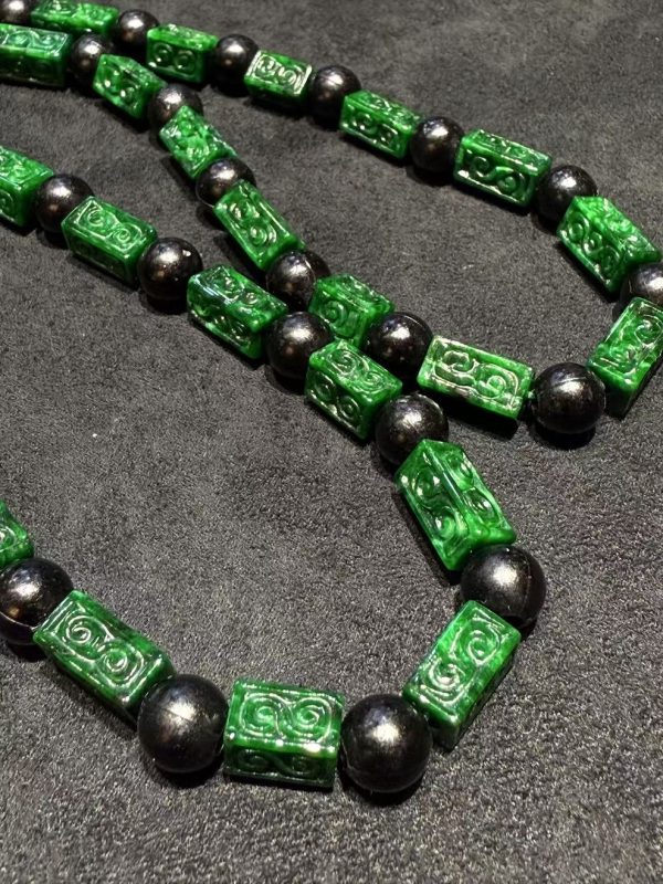 Vibrant dark green Ruyi cloud carving jade necklace with black beads