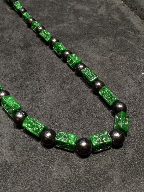 Vibrant dark green Ruyi cloud carving jade necklace with black beads