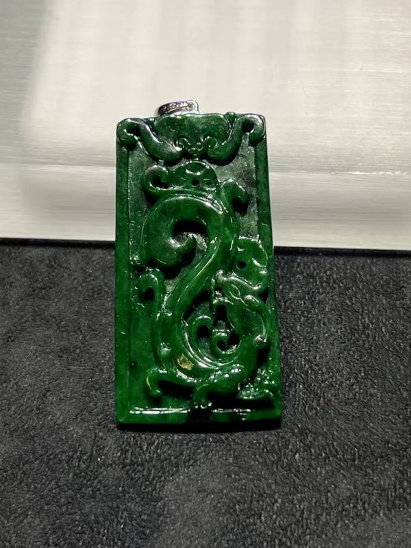 Translucent vibrant dark green dragon carving jade pendant