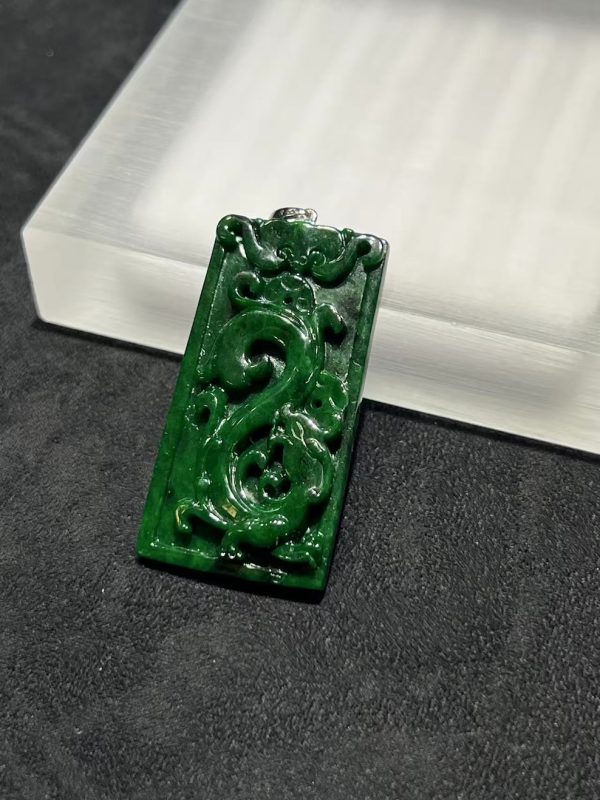 Translucent vibrant dark green dragon carving jade pendant