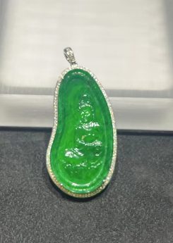 Icy translucent vibrant green Guanyin jadeite pendant with diamond setting in 18K white gold