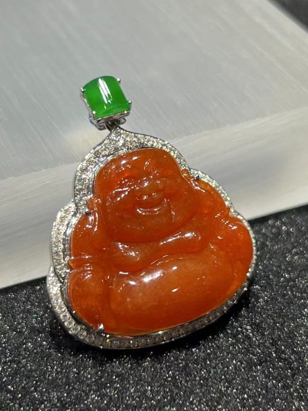 Translucent vibrant reddish Laughing Buddha jadeite pendant with green jade cabochon and diamond setting