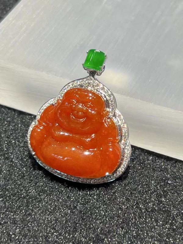 Translucent vibrant reddish Laughing Buddha jadeite pendant with green jade cabochon and diamond setting
