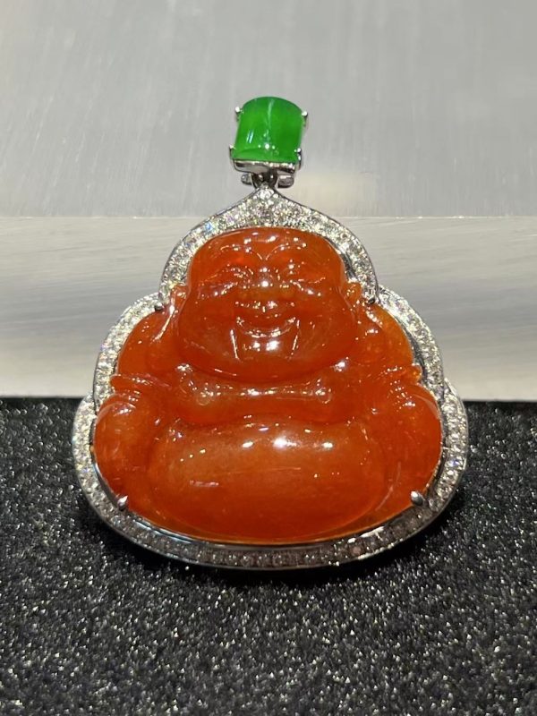 Translucent vibrant reddish Laughing Buddha jadeite pendant with green jade cabochon and diamond setting