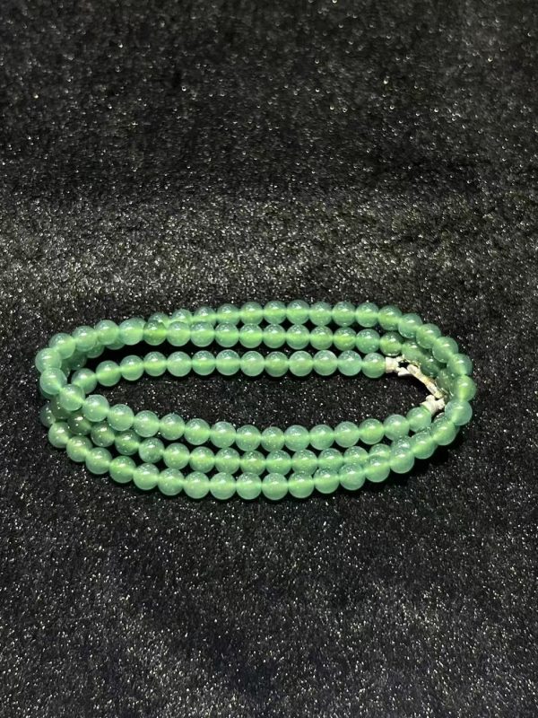 Translucent bluish jade bead necklace made from natural Type A jadeite, featuring luminous blue-green beads with elegant soft shine.