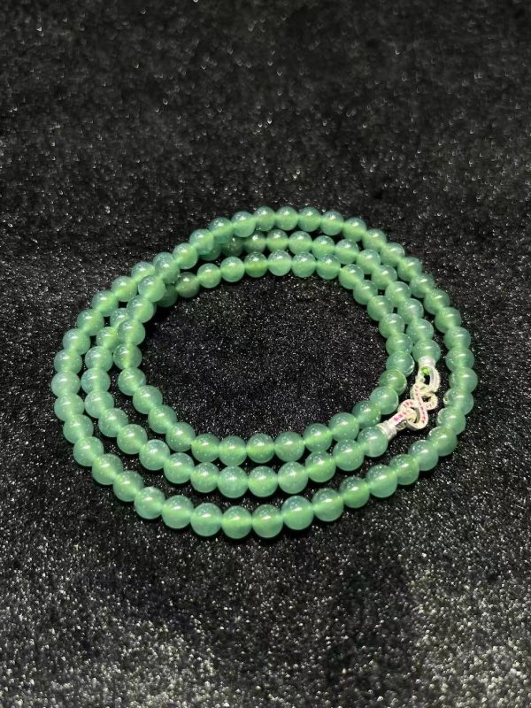 Translucent bluish jade bead necklace made from natural Type A jadeite, featuring luminous blue-green beads with elegant soft shine.
