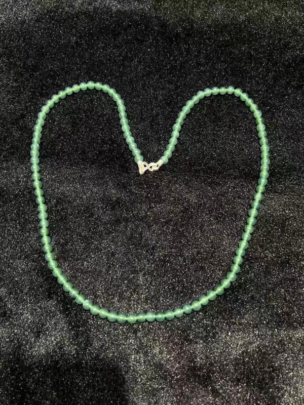 Translucent bluish jade bead necklace made from natural Type A jadeite, featuring luminous blue-green beads with elegant soft shine.