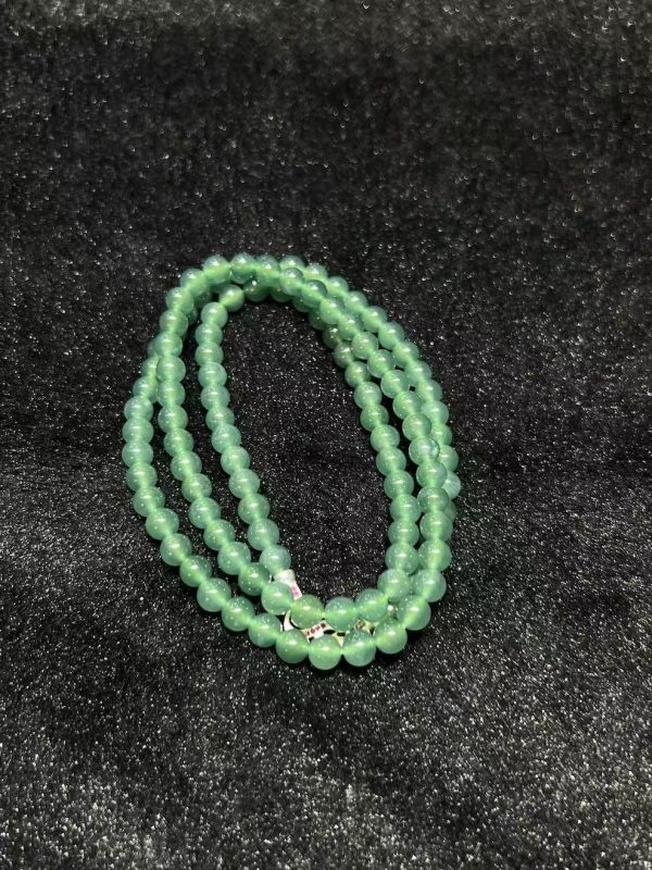 Translucent bluish jade bead necklace made from natural Type A jadeite, featuring luminous blue-green beads with elegant soft shine.