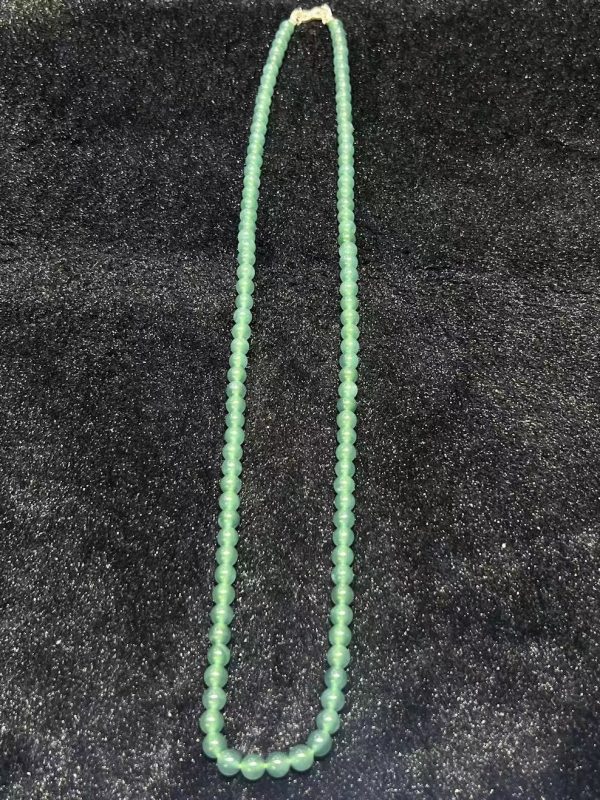 Translucent bluish jade bead necklace made from natural Type A jadeite, featuring luminous blue-green beads with elegant soft shine.