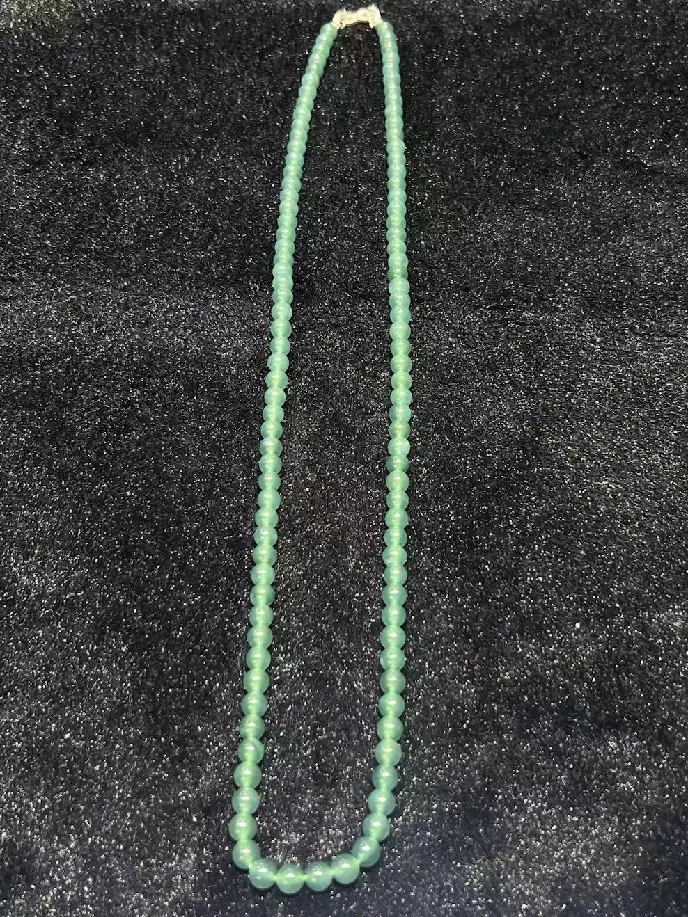 Translucent bluish jade bead necklace made from natural Type A jadeite, featuring luminous blue-green beads with elegant soft shine.