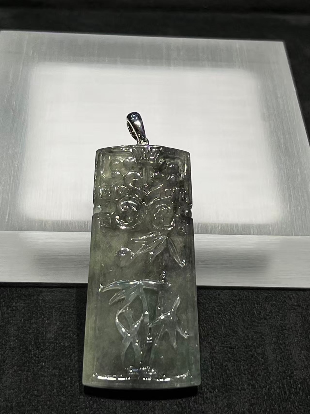 translucent grey jadeite pendant with bamboo carving