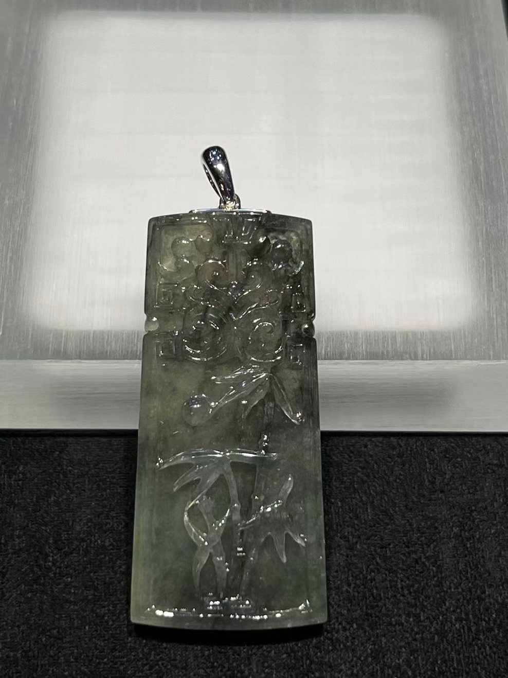 translucent grey jadeite pendant with bamboo carving