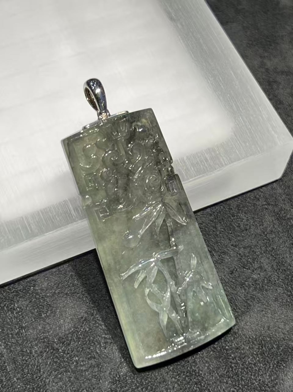 translucent grey jadeite pendant with bamboo carving
