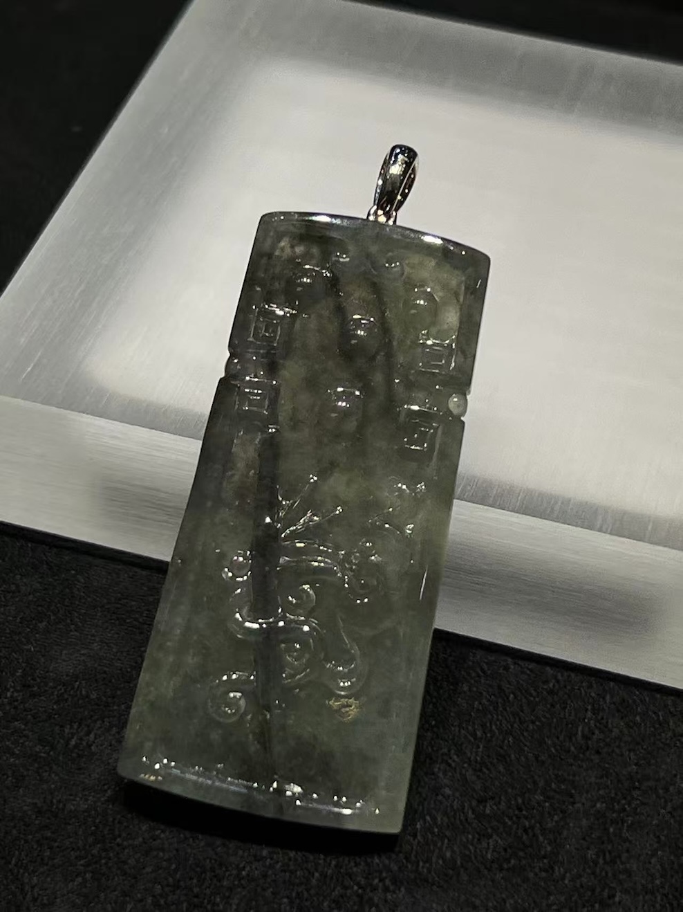 translucent grey jadeite pendant with bamboo carving