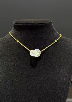 Icy translucent double safety-knot jadeite pendant on 18K yellow gold necklace.