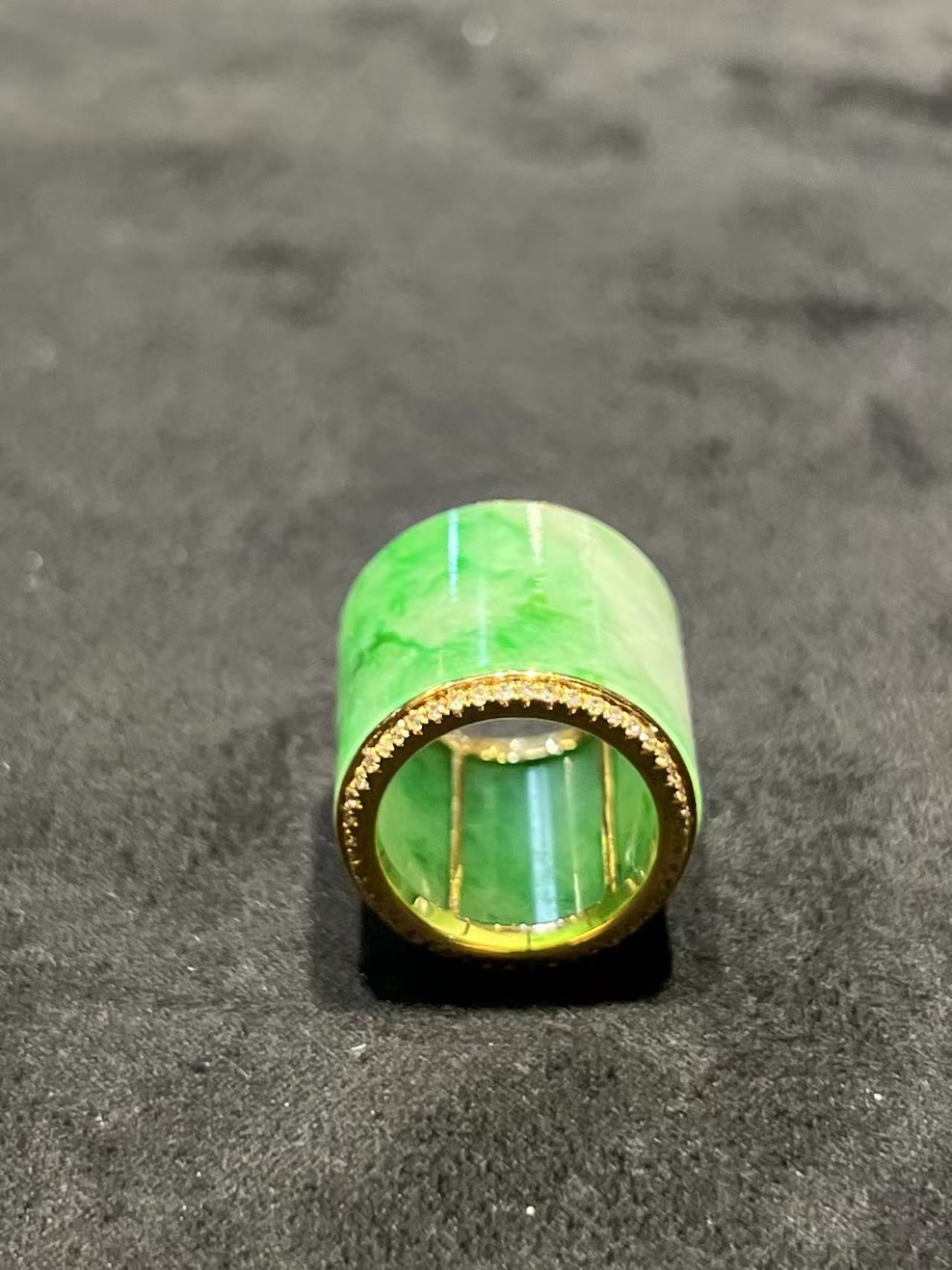 Translucent white-green jadeite barrel pendant set in 18K yellow gold with diamond rims, symbolizing prosperity and balance