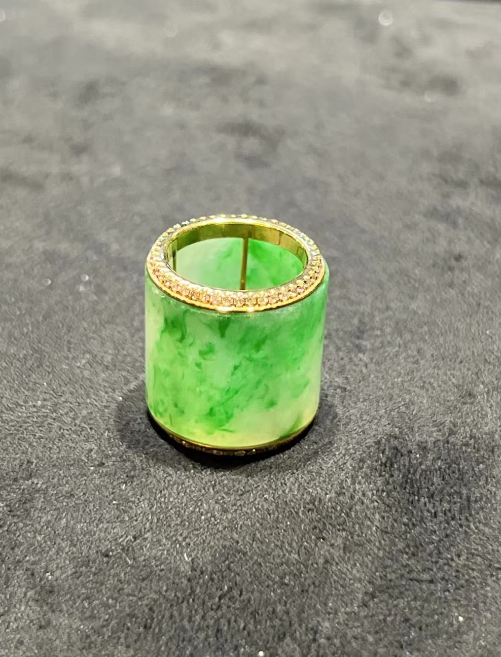 Translucent white-green jadeite barrel pendant set in 18K yellow gold with diamond rims, symbolizing prosperity and balance