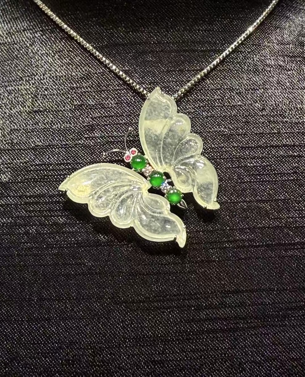 Highly translucent icy butterfly jadeite pendant and brooch with diamonds, pink sapphires, and green jade cabochons.