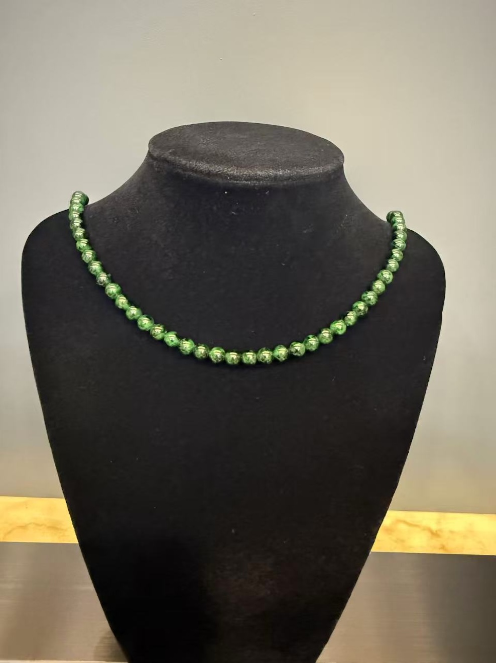 Translucent old pit green jadeite beads necklace with brass clasp, featuring vivid green colour and smooth polished surface