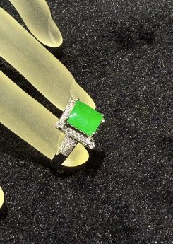 Highly translucent vivid green square-cut jadeite ring with diamond halo