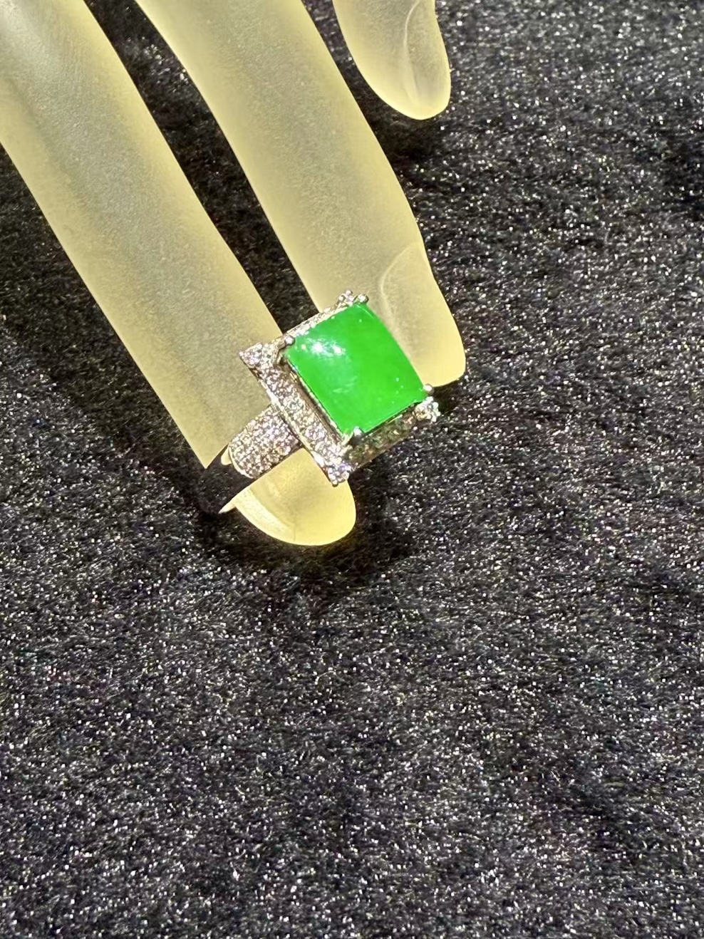 Highly translucent vivid green square-cut jadeite ring with diamond halo