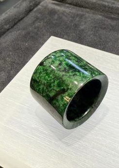 Semi-translucent dark green jade archer ring with natural textures