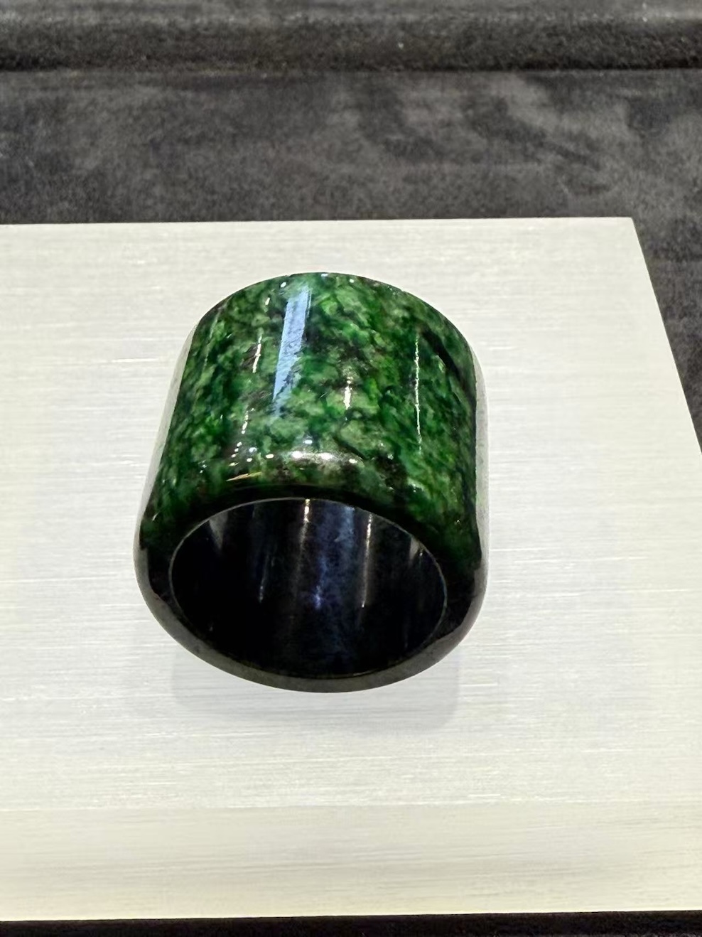 Semi-translucent dark green jade archer ring with natural textures