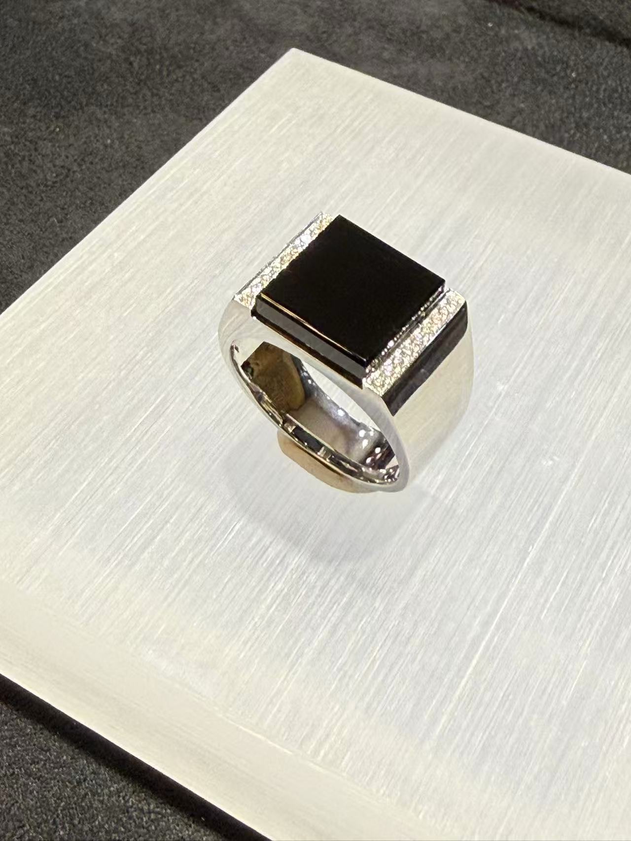 translucent omphacite black jadeite ring set in 18K white gold with diamond accents