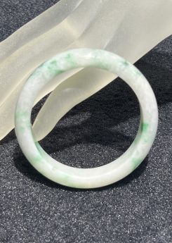 Translucent green patches jadeite bangle