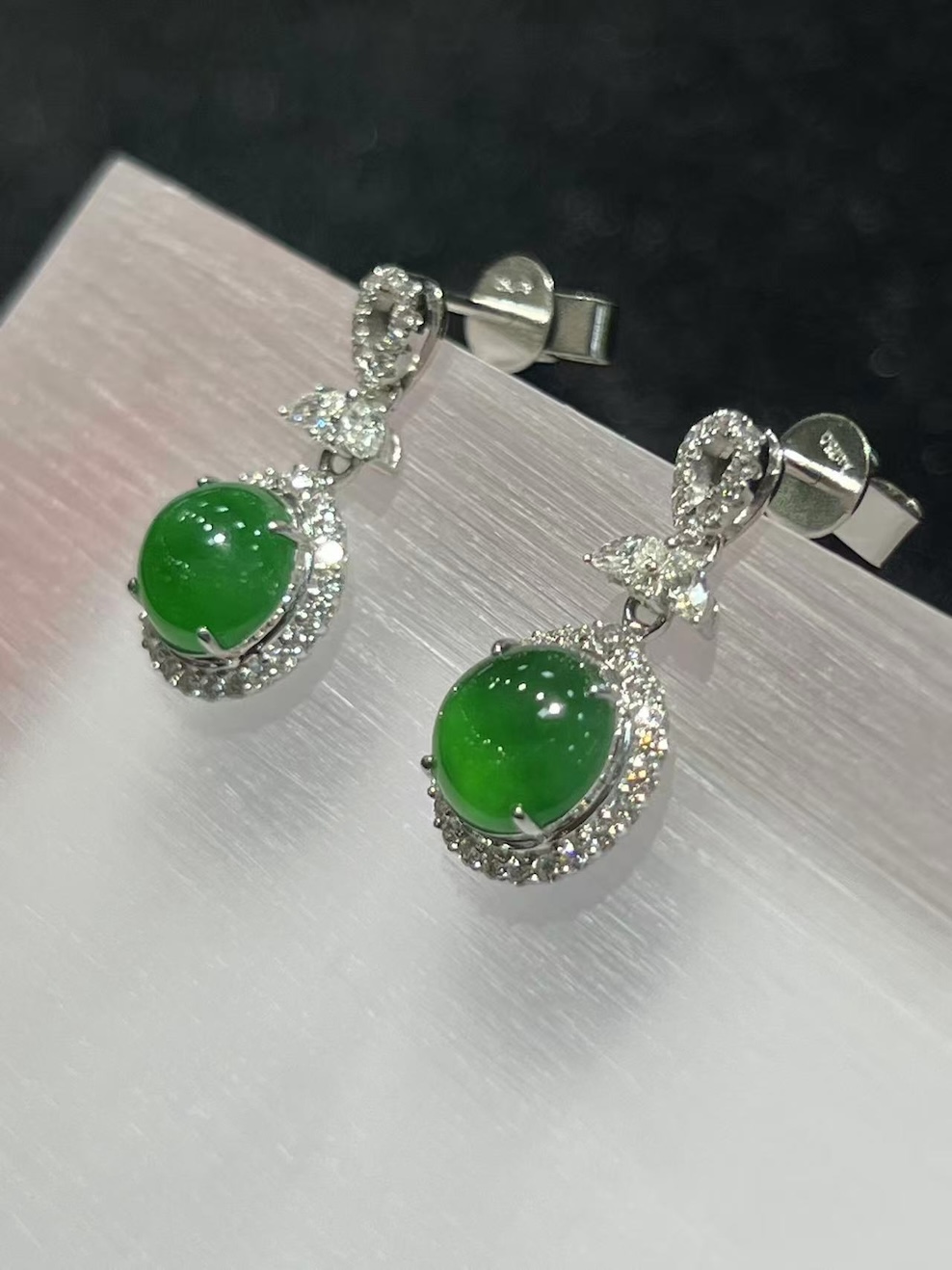 Jadeite cabochon earrings with icy green translucent stones and diamond halo