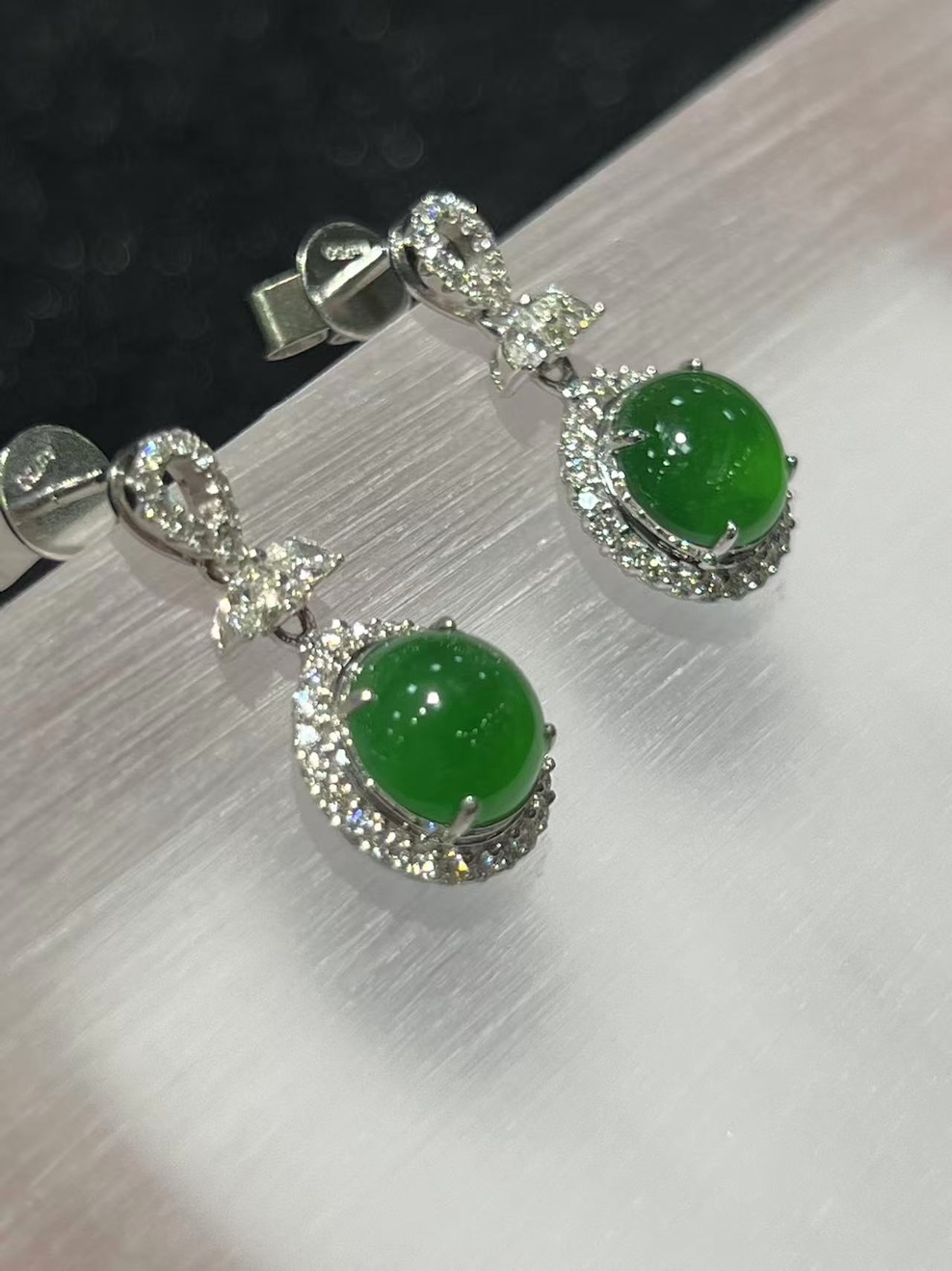 Jadeite cabochon earrings with icy green translucent stones and diamond halo