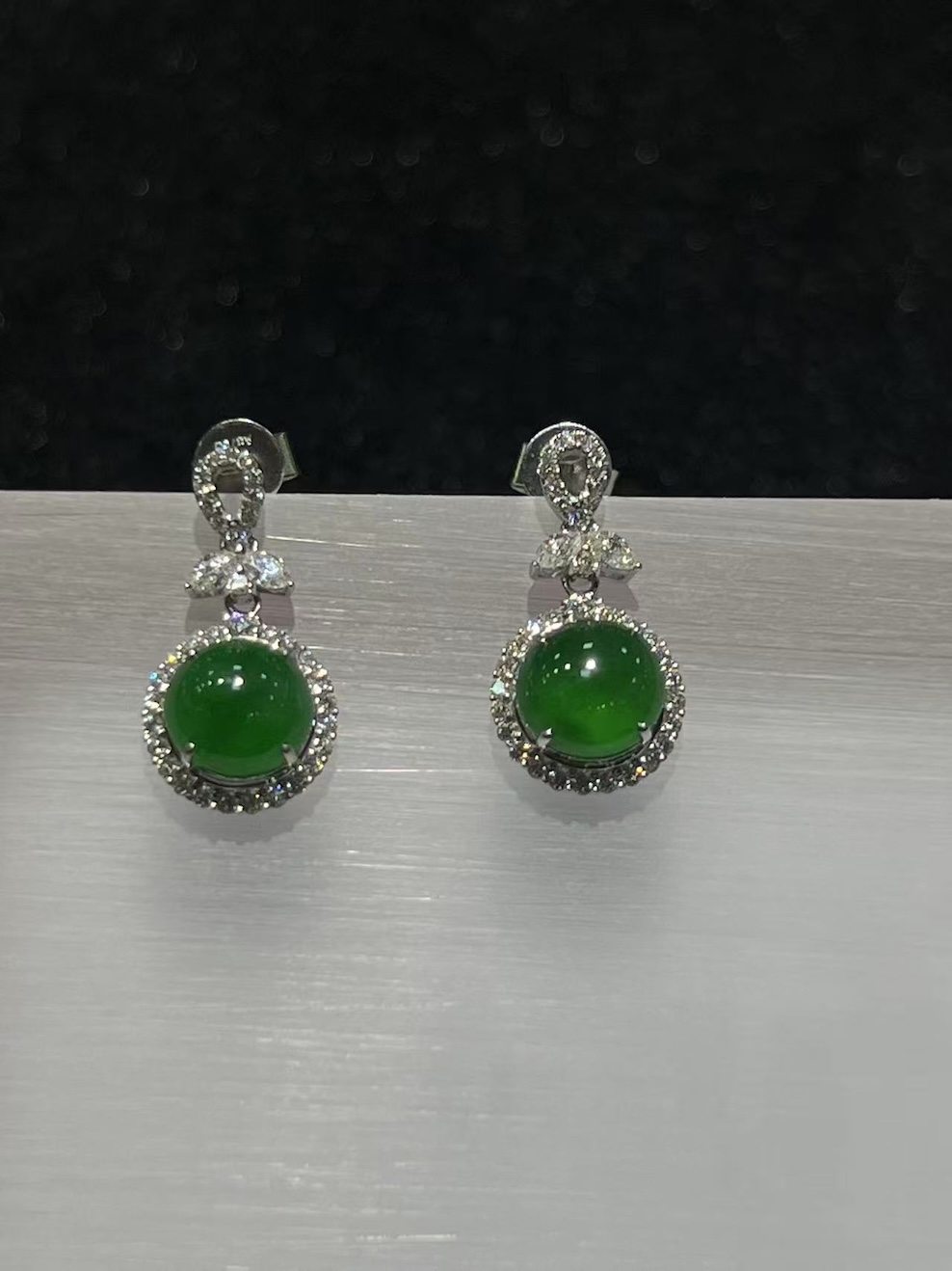 Jadeite cabochon earrings with icy green translucent stones and diamond halo