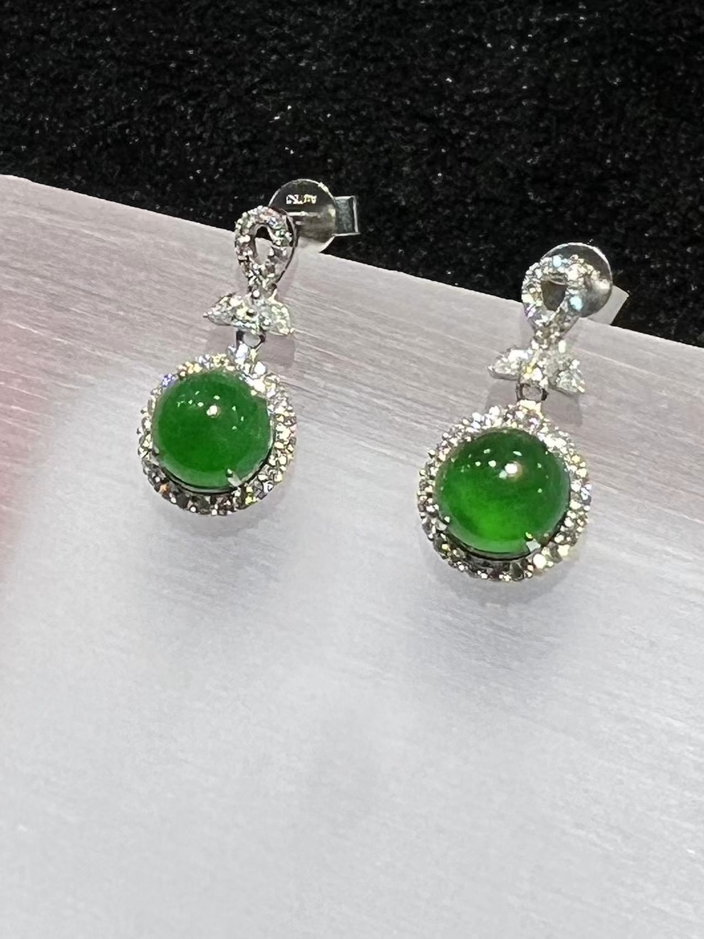 Jadeite cabochon earrings with icy green translucent stones and diamond halo