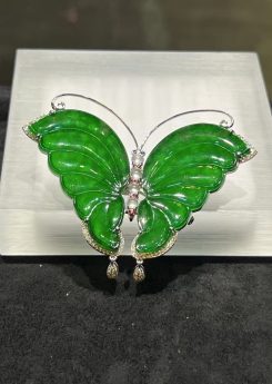 Translucent vibrant green butterfly jadeite pendant brooch set in 18k white gold with diamonds and pink sapphires