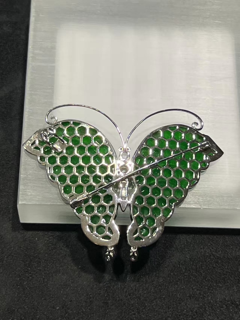 Translucent vibrant green butterfly jadeite pendant brooch set in 18k white gold with diamonds and pink sapphires