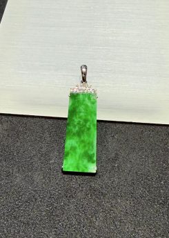 Translucent vibrant green Ping An Wu Shi jadeite pendant set in 18K white gold with diamonds